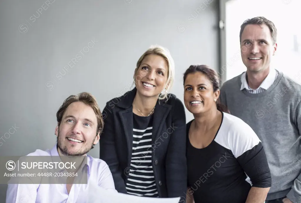 Business colleagues looking away together in office