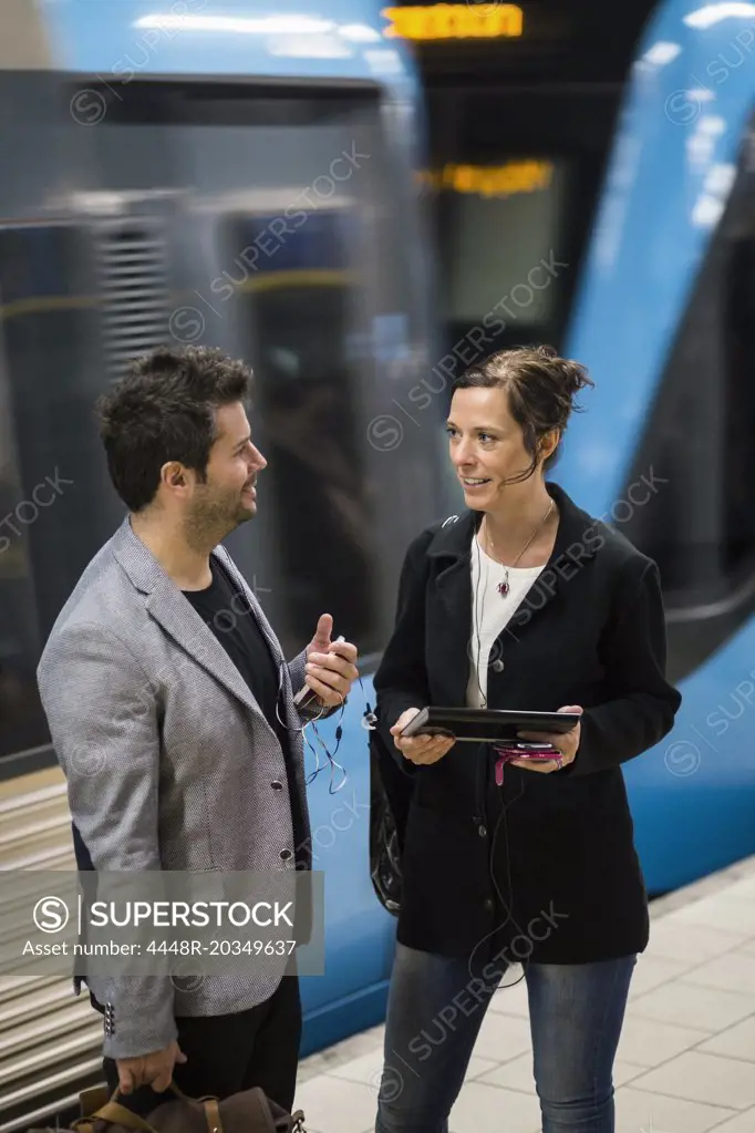 Businessman and businesswoman communication at subway station