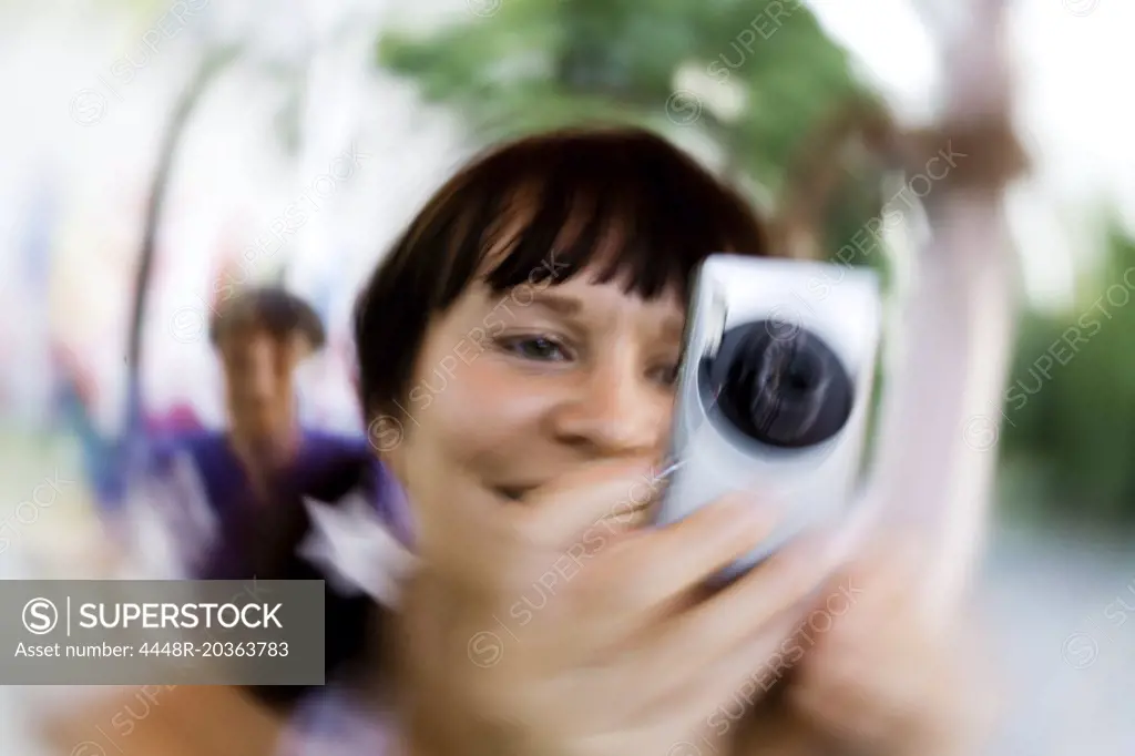 Woman taking pictures of the surroundings