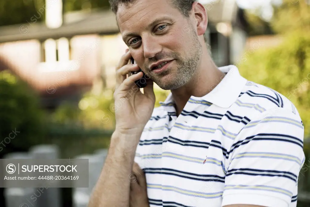 Man with striped sweater making a phonecall