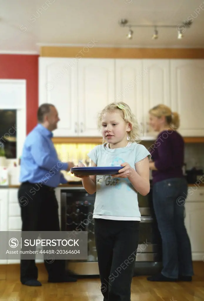 Child cleaning helping out in kitchen