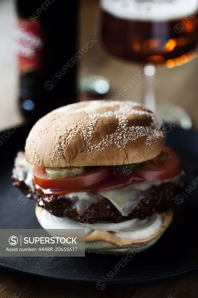 Hamburger and wineglass on table
