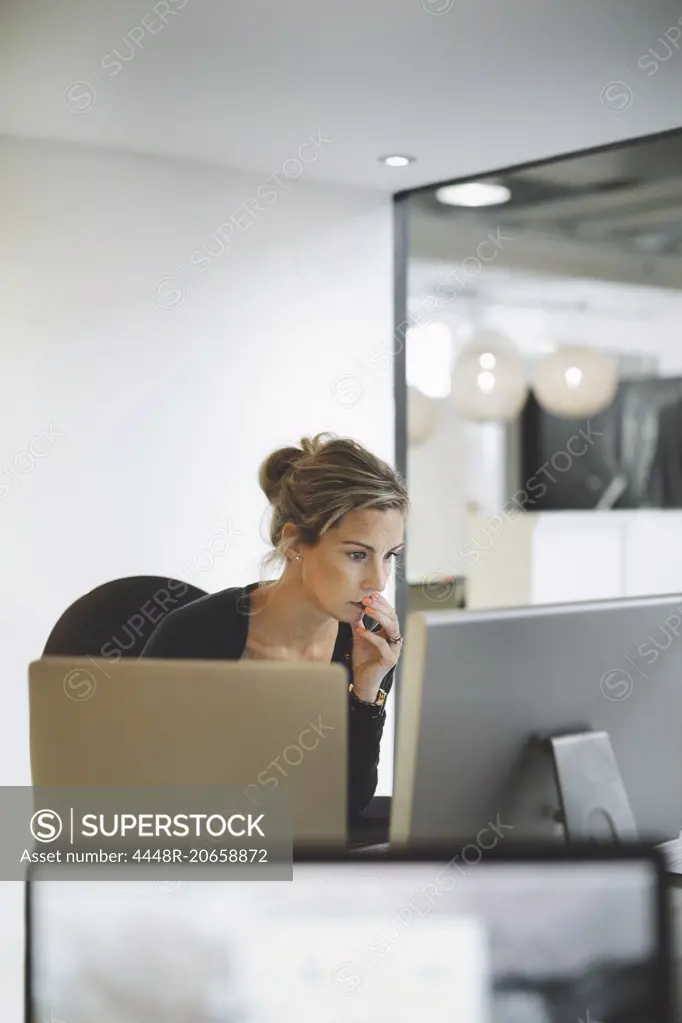 Mature businesswoman using desktop computer in office