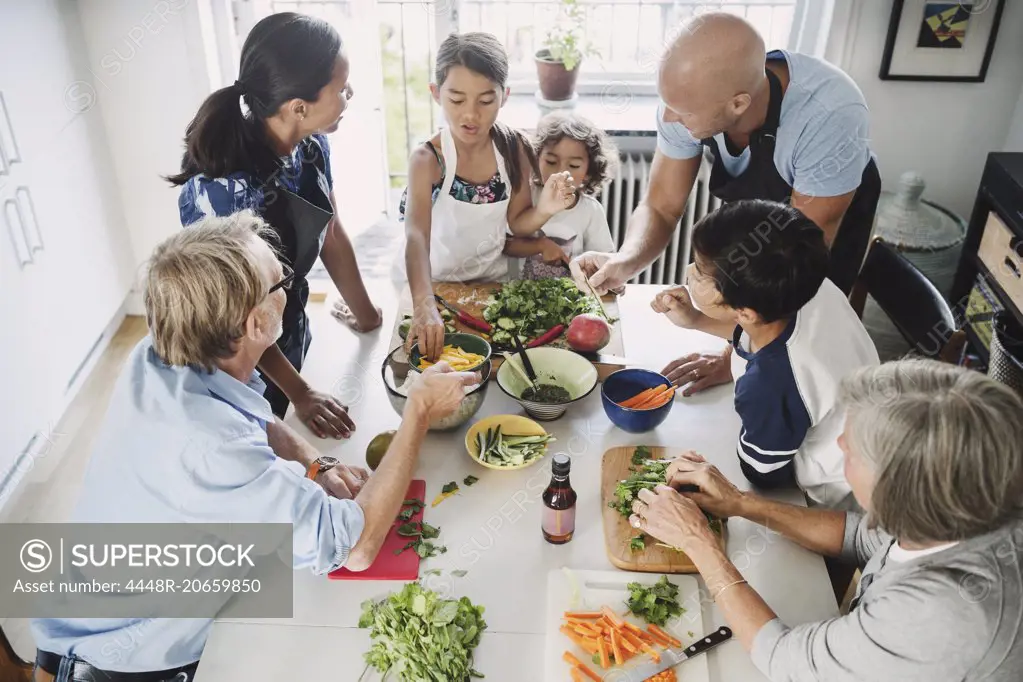 High angle view of family preparing Asian food at table