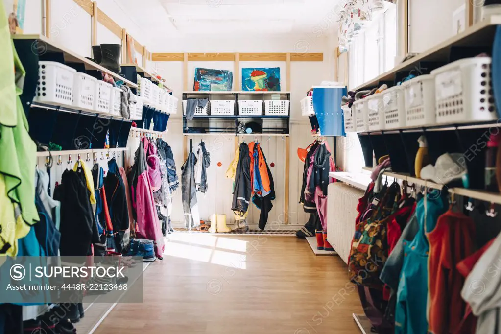Various clothes hanging in cloakroom at preschool