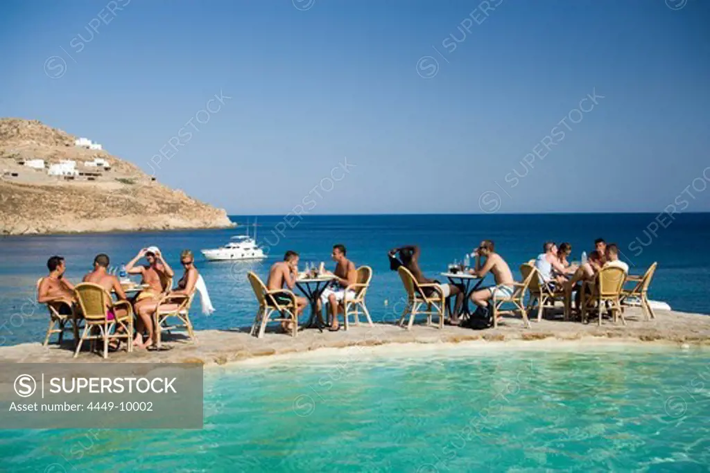 People sitting in the Coco Club at Super Paradise Beach, Psarou, Mykonos, Greece