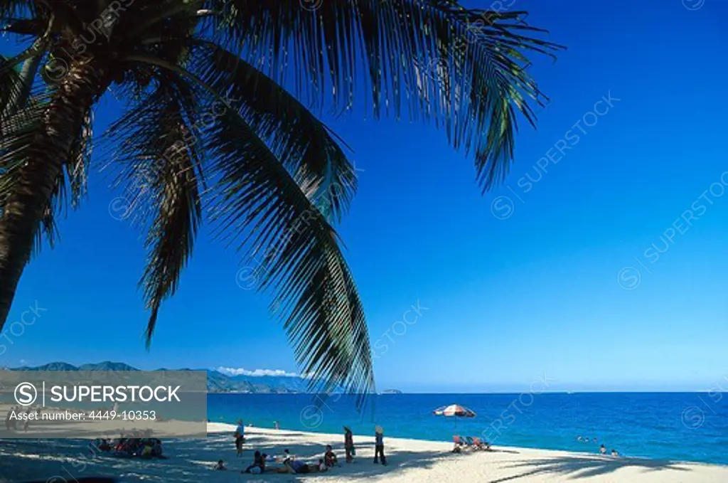 Palm tree and people at Nha Trang Beach, Vietnam, Asia