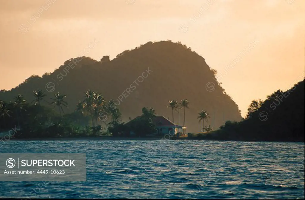 House on the waterfront and mountain at sunset, Iles des Saintes, Guadeloupe, Caribbean, America