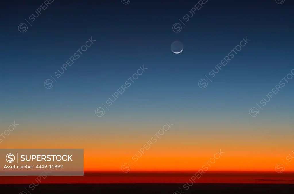 Crescent of moon above Horizon after sunset