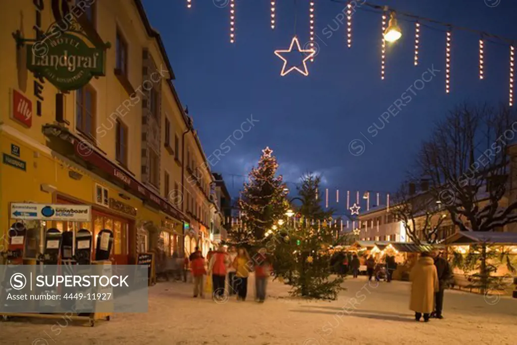 People walking over the christmas market at Hauptplatz in the evening, Schladming, Styria, Austria