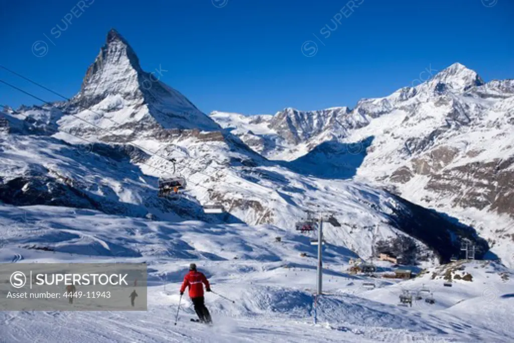 Skiers on mountain slope, Matterhorn (4478 m) in background, Zermatt, Valais, Switzerland