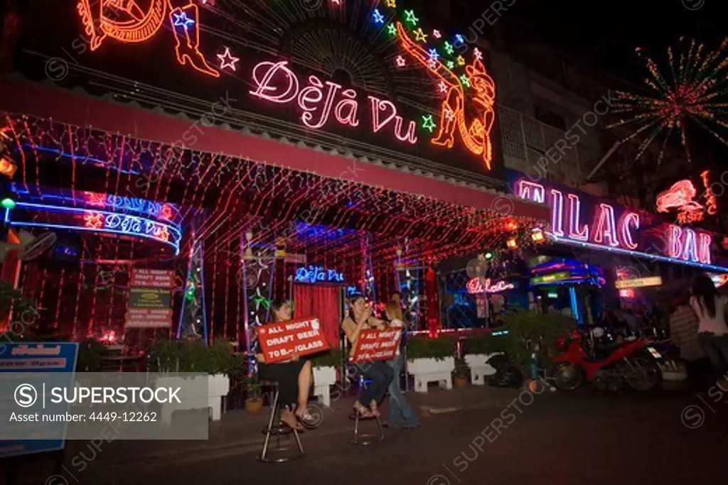Women sitting in front of Go-go bar ""DeJa Vu"" and presenting signs, Soi Cowboy, a red-light district, Th Sukhumvit, Bangkok, Thailand