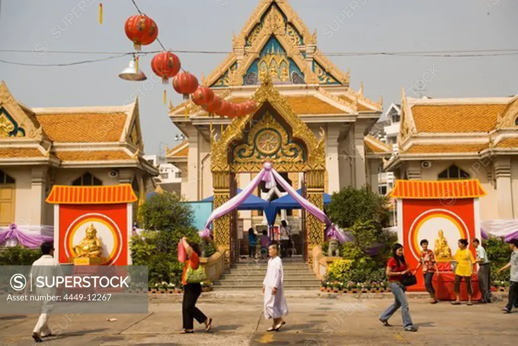 People visiting Wat Suthat, decorated for the Chinese New Year, Bangkok, Thailand