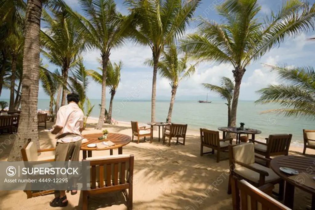 Waiter setting the table in the beach restaurant of the Santiburi Dusit Resort, Mae Nam Beach, Hat Mae Nam, Ko Samui, Thailand