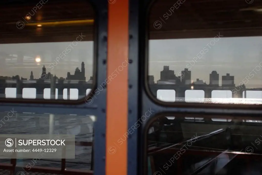 Windows of a ferry reflecting Manhattan's skyline, Manhattan, New York, America, USA