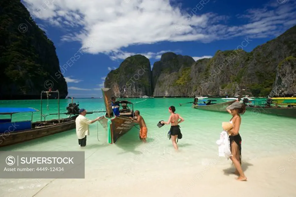 Tourists next to anchored boats in the Maya Bay, a beautiful scenic lagoon, famous for the Hollywood film ""The Beach"", Ko Phi-Phi Leh, Ko Phi-Phi Islands, Krabi, Thailand, after the tsunami