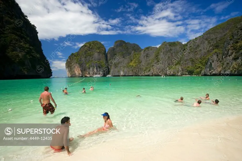 Tourists next to anchored boats in the Maya Bay, a beautiful scenic lagoon, famous for the Hollywood film ""The Beach"", Ko Phi-Phi Leh, Ko Phi-Phi Islands, Krabi, Thailand, after the tsunami