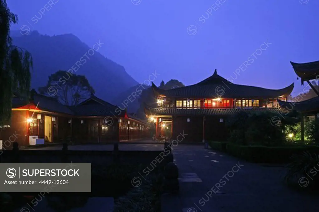 View at illuminated windows of Wannian monastery in the evening, Emei Shan, Sichuan Province, China, Asia