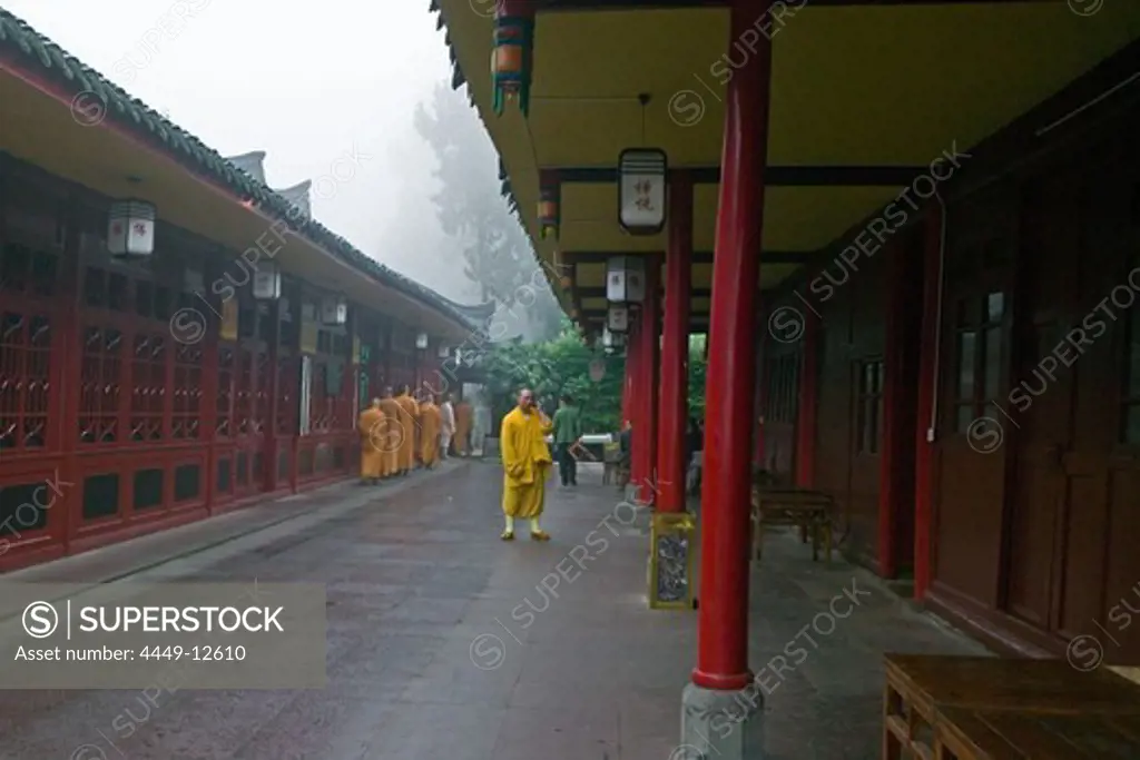 Monks at the courtyard of the Wannian monastery, Emei Shan, Sichuan province, China, Asia