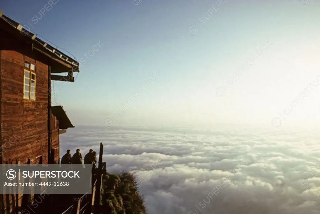 People in front of hostel of Jinding Monastery with view at sea of clouds, Emei Shan mountains, Sichuan province, China, Asia