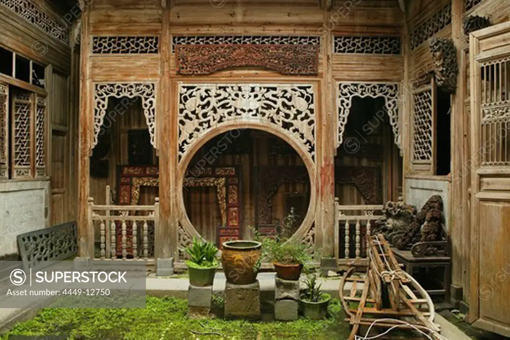 courtyard with elaborate carved timber screens, pot plants, Hongcun, ancient village, living museum, China, Asia, World Heritage Site, UNESCO