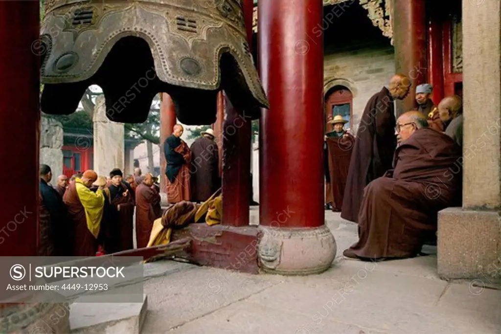 Buddhist monks honouring Wenshus at the birthday celebrations, red columns of temple, Xiantong Monastery, Wutai Shan, Five Terrace Mountain, Buddhist Centre, town of Taihuai, Shanxi province, China