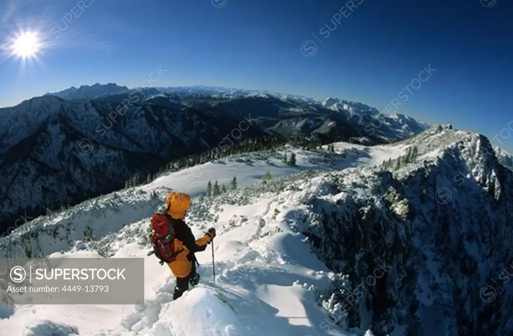 Mountaineerer on snow-covered west ridge of Hoerndlwand, view to range of Loferer Steinberge and Kaisergebirge, Bavarian Alps, Chiemgau, Upper Bavaria, Bavaria, Germany