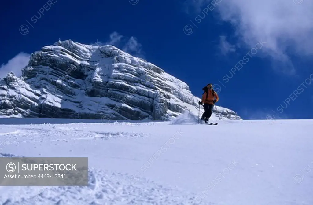 Backcountry skier on Gosau glacier with Dachstein, Upper Austria, Austria