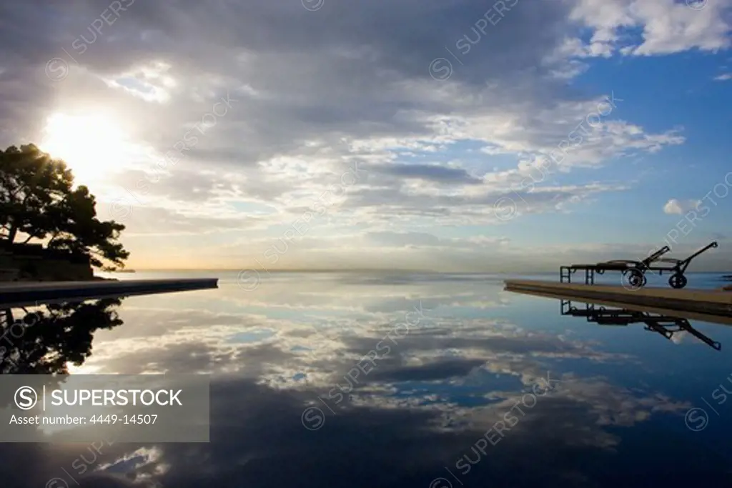 Hotel Maricel swimming pool at sunrise with water reflection, Palma, Majorca, Spain
