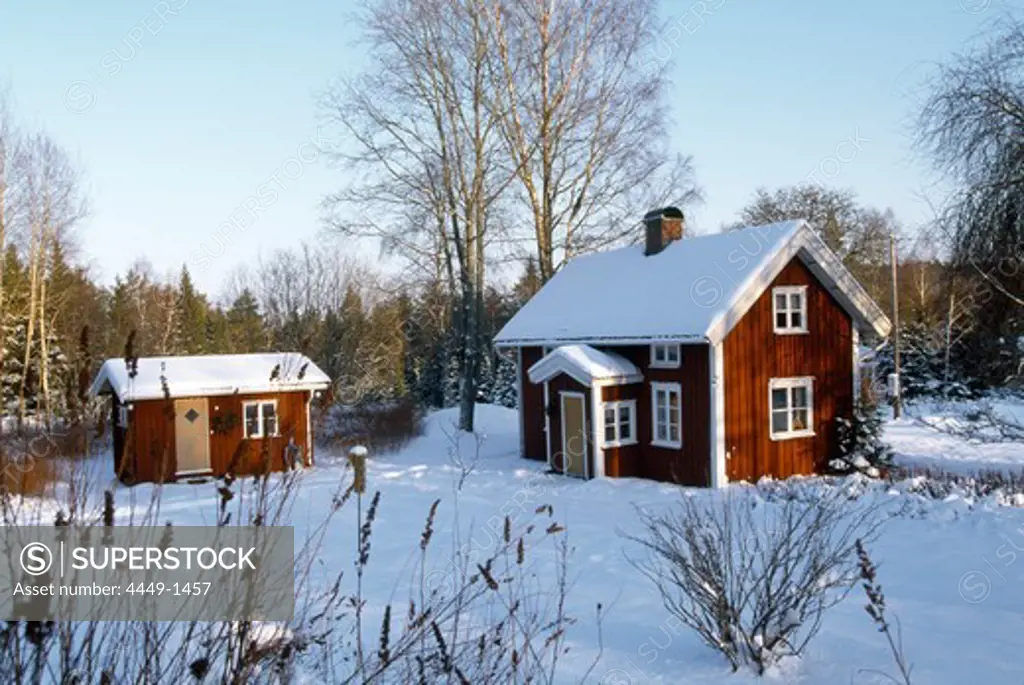 Wooden houses in snow covered scenery, Vastergotland, Sweden