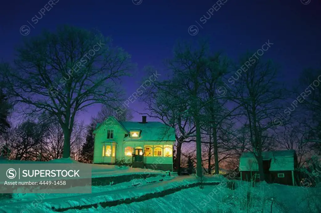 Residential house with illuminated windows on a winter's evening, Kinna, Vaester Goetland, Sweden, Europe
