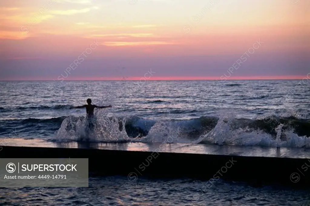 Swimmer standing on jetty of Havsbad, Visby, Gotland, Sweden