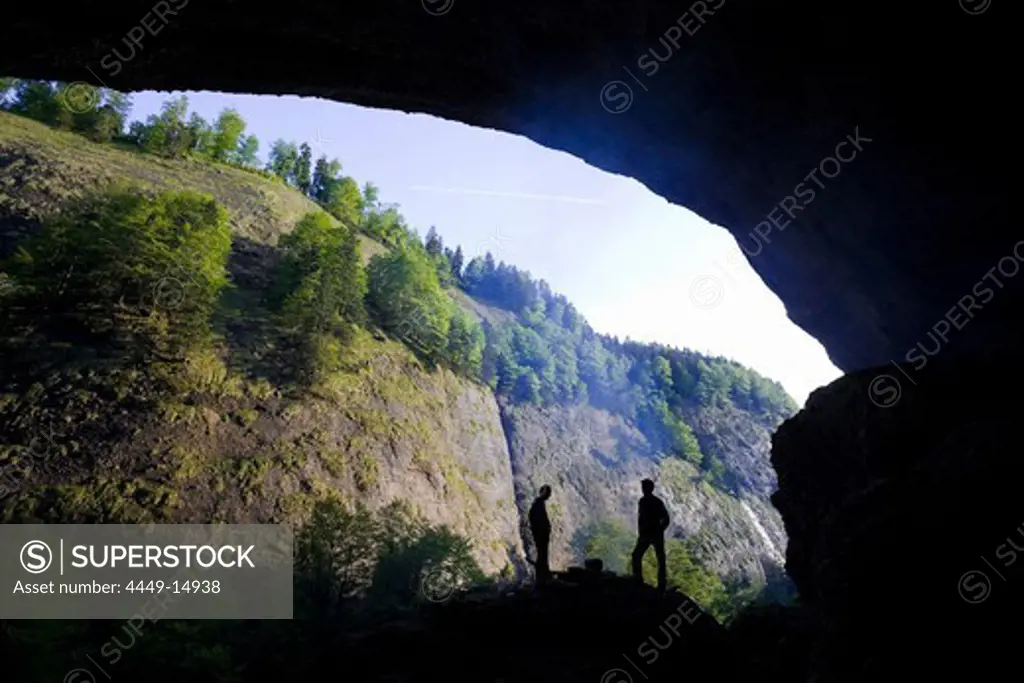 Hikers resting near grotto, Ofenloch gorge, Canton St. Gallen, Switzerland