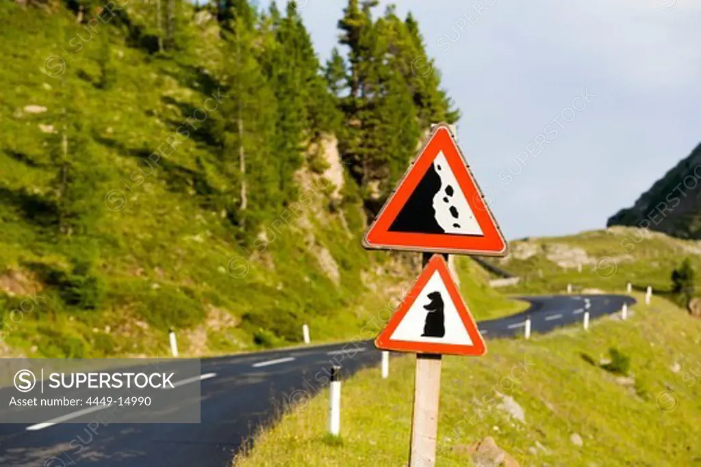 Danger warning road signs falling rocks and marmots at Nockalm Road, Nock Mountains (unique kind of Alpine mountains), Carinthia, Austria