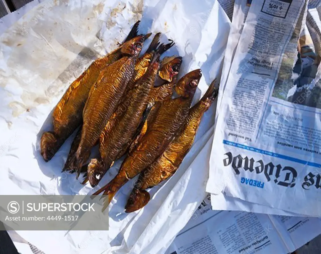 Smoked herring on a newspaper, Bormholm, Denmark, Europe