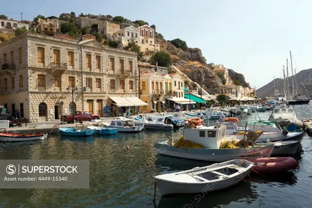 Fishing boats and rowboats anchoring in harbour Gialos, Simi, Symi Island, Greece