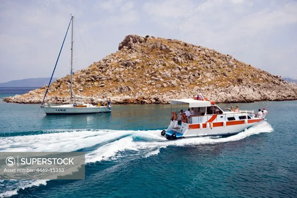 Taxi boat and sailing boat in bay near Agia Marina Beach, Pedi, Symi Island, Greece