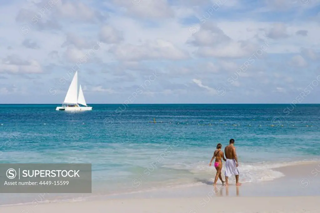 Catamaran and Couple on Eagle Beach, Aruba, Dutch Caribbean
