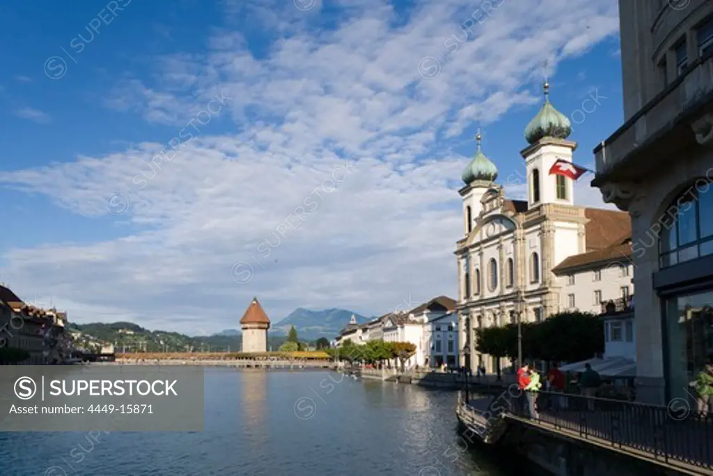 View along river Reuss with Jesuit Curch, first large sacral baroque building in Switzerland, and Kapellbruecke (chapel bridge, oldest covered bridge of Europe) with Wasserturm, Lucerne, Canton Lucerne, Switzerland