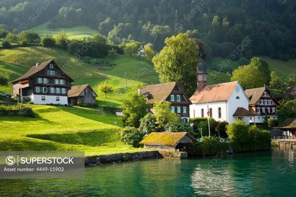 View over Lake Lucerne to Kehrsiten Dorf with church, Canton of Lucerne, Switzerland