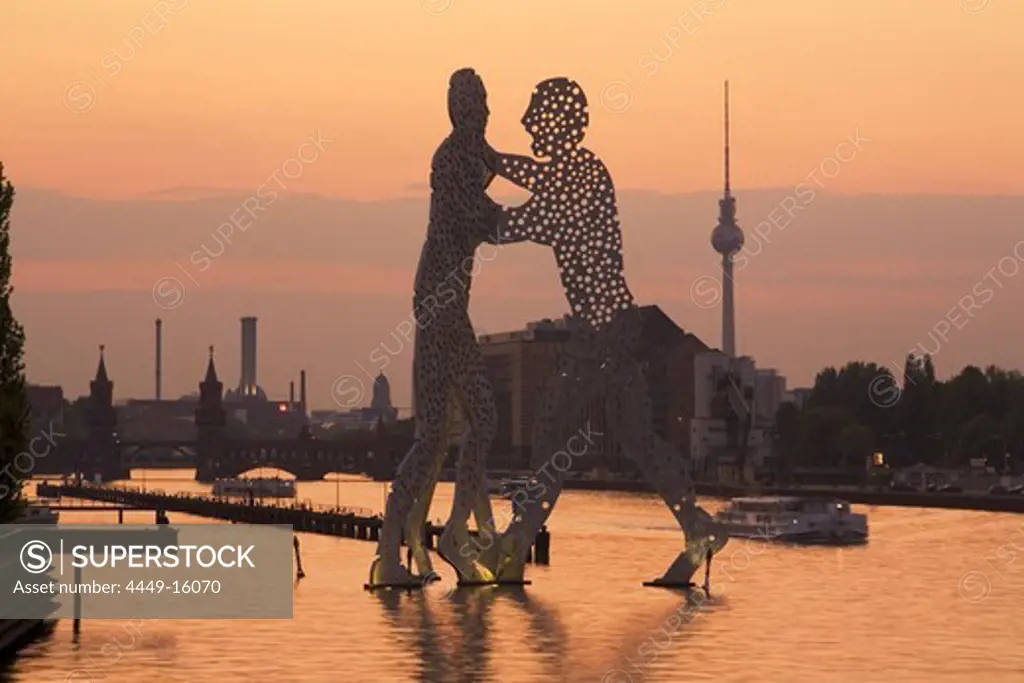 Molecular Men sculpture at River Spree with Alex TV Tower in Background, Berlin, Germany