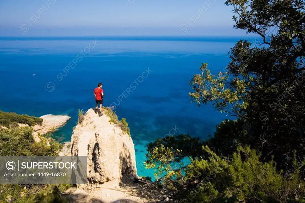 Golfo di Orosei, Sardinia, a young man enjoys the view over the sea, Italy, MR