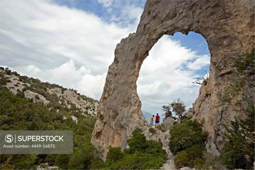 Rock arch s'Architeddu Lupiru on the adventurous trekking Il Sentiereo Selvaggio Blu, Sardinia, Golfo di Orosei, Italy., MR