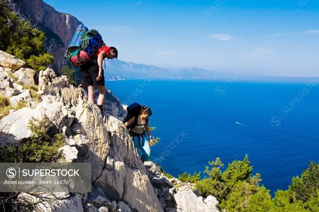 A young men and a young woman hiking, Il Sentiereo Selvaggio Blu, Sardinia, Golfo di Orosei, Italy