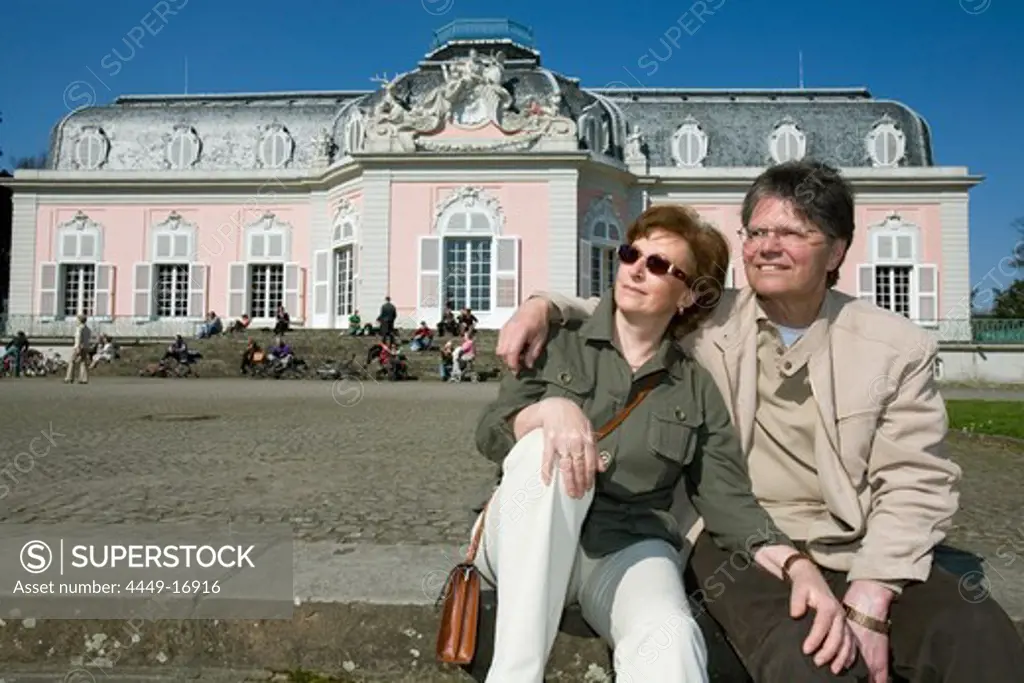 old couple sitting in front of the castle of Benrath, world heritage of UNESCO, sightseeing spot, local recreation area, Duesseldorf, state capital of NRW, North-Rhine-Westphalia, Germany