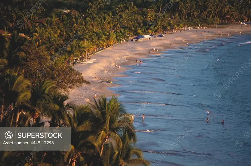 Coast showing sandy beach and palm trees, Playa la ropa, Zihuatanejo, Guerrero, Mexico, America