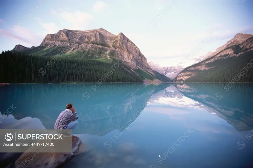 Man enjoying views at Lake Louise, Rocky Mountains, Alberta, Canada