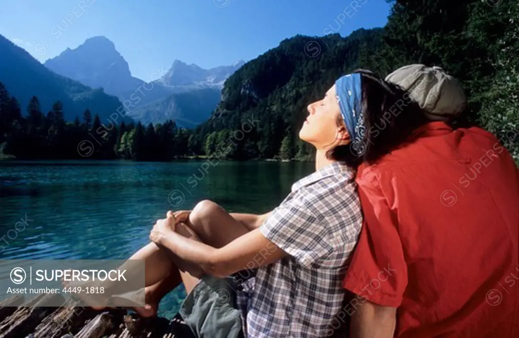 Couple of hikers relaxing at mountain lake, Hutterer Hoess, Kalkalpen, Muehlviertel, Upper Austria, Austria