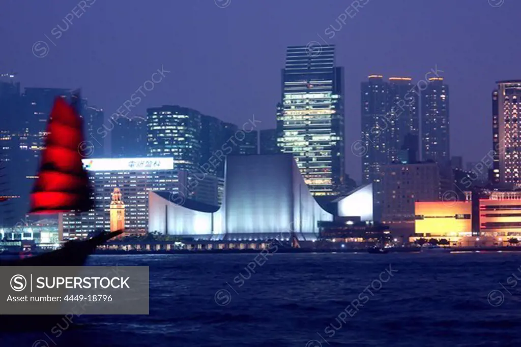 Old Dhow in front of Hong Kong skyline at night, Hong Kong, China