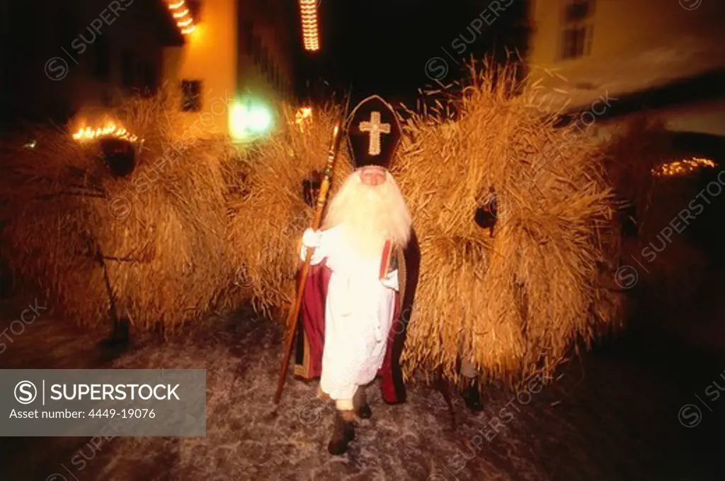 Santa Claus and Buttnmandl, young men dressed in straw, roaming the town during advent, Berchtesgaden, Upper Bavaria, Germany